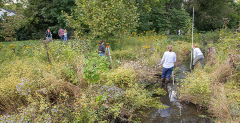 students working near stream